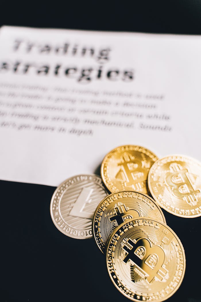 about-bg Close-up of Bitcoin and Litecoin coins on a trading strategies document.